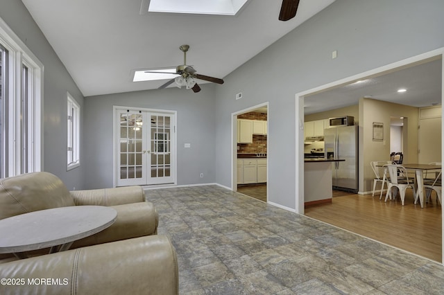 1299 E County Line Rd, Lakewood, NJ 08701 - living room with ceiling fan, a skylight, lofted ceiling, french doors, and baseboards