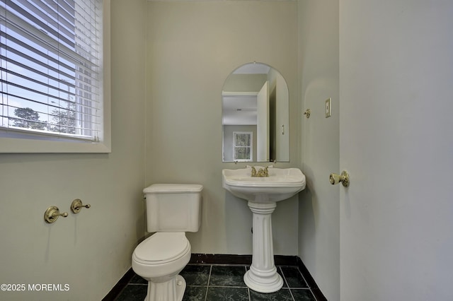 1299 E County Line Rd, Lakewood, NJ 08701 - half bathroom featuring toilet, baseboards, tile patterned floors, and plenty of natural light