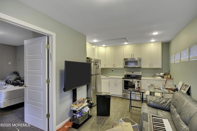 1299 E County Line Rd, Lakewood, NJ 08701 - kitchen featuring stainless steel appliances, light wood-style flooring, a sink, light countertops, and open floor plan