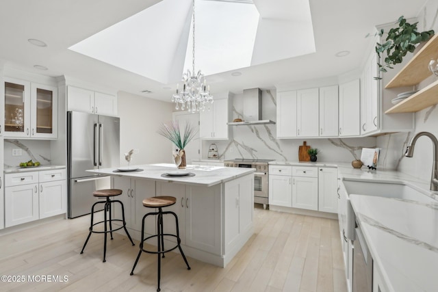 8 Olden Ct, Colts Neck, NJ 07722 - kitchen with high quality appliances, wall chimney exhaust hood, white cabinets, and recessed lighting