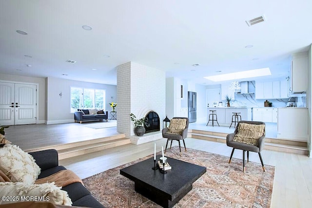8 Olden Ct, Colts Neck, NJ 07722 - living room with light wood finished floors and a fireplace