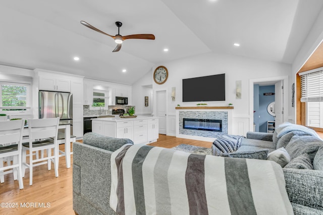 5 Westbrook Cir, Howell, NJ 07731 - living area with vaulted ceiling, ceiling fan, light wood-type flooring, a glass covered fireplace, and recessed lighting
