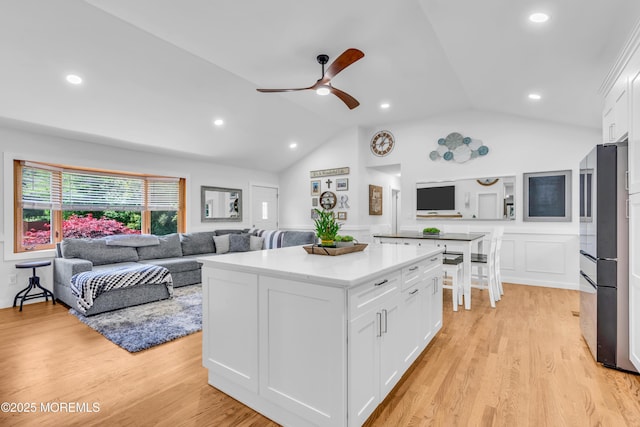 5 Westbrook Cir, Howell, NJ 07731 - kitchen featuring refrigerator, lofted ceiling, white cabinets, ceiling fan, and a center island