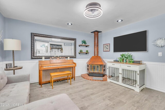 5 Westbrook Cir, Howell, NJ 07731 - living area with a wainscoted wall, a wood stove, and wood finished floors