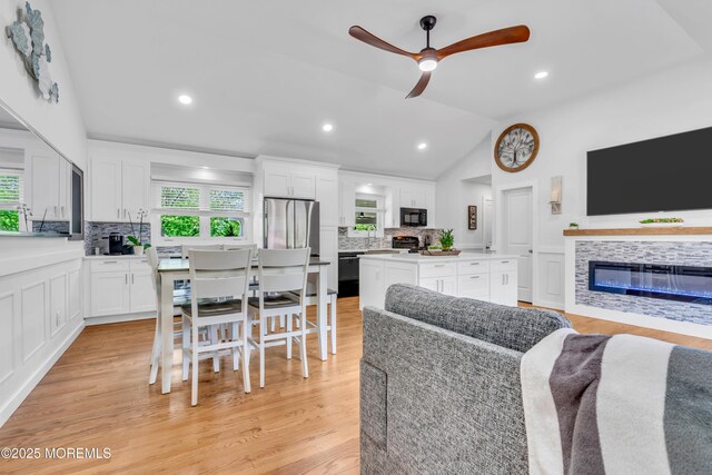 5 Westbrook Cir, Howell, NJ 07731 - living area with vaulted ceiling, a fireplace, ceiling fan, light wood finished floors, and recessed lighting