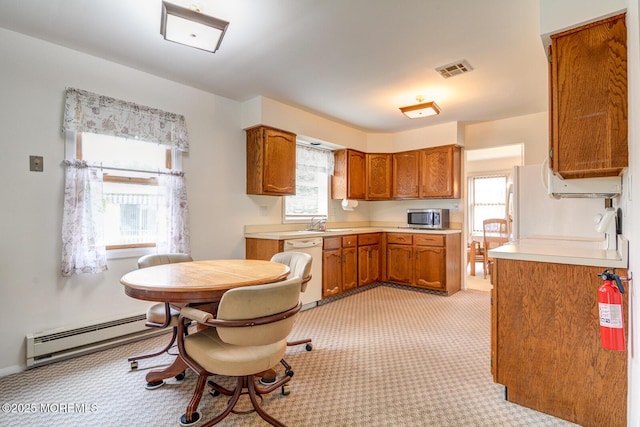 2 Thames Pl, Brick, NJ 08723 - kitchen featuring stainless steel microwave, a baseboard radiator, brown cabinetry, light colored carpet, and light countertops