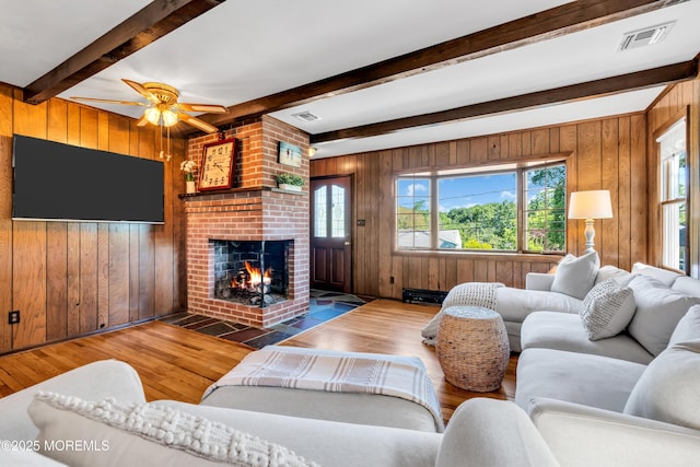 162 Delaware Ave, Atlantic Highlands, NJ 07716 - living room featuring wooden walls, wood finished floors, healthy amount of natural light, a fireplace, and ceiling fan