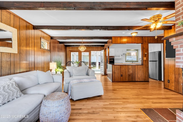 162 Delaware Ave, Atlantic Highlands, NJ 07716 - living area featuring wooden walls, light wood-style floors, beam ceiling, healthy amount of natural light, and a ceiling fan
