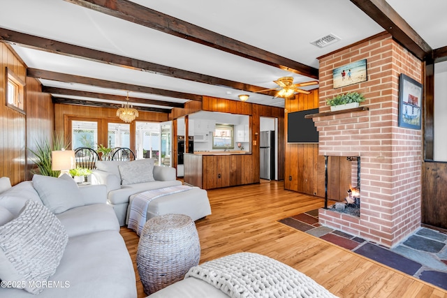 162 Delaware Ave, Atlantic Highlands, NJ 07716 - living area featuring wood walls, beam ceiling, light wood finished floors, ceiling fan, and a brick fireplace