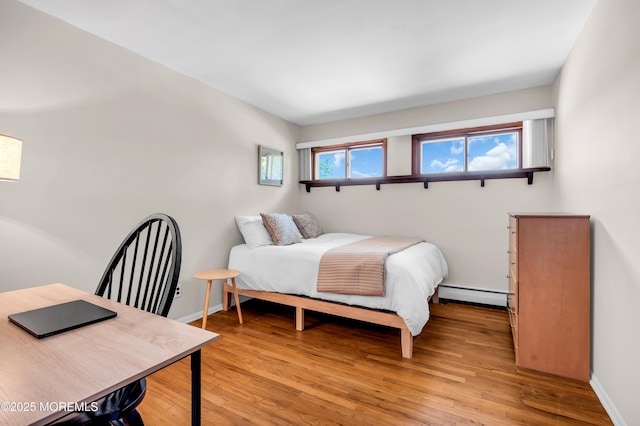 162 Delaware Ave, Atlantic Highlands, NJ 07716 - bedroom with baseboard heating, light wood-type flooring, and baseboards