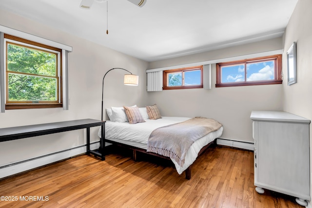 162 Delaware Ave, Atlantic Highlands, NJ 07716 - bedroom featuring a baseboard radiator, multiple windows, and light wood-style floors