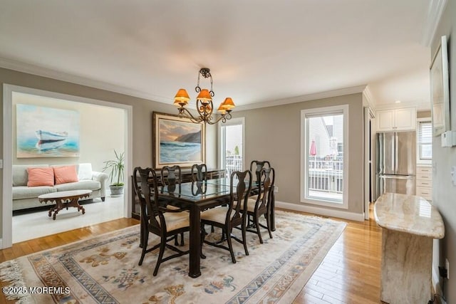 580 Patten Ave # 53, Long Branch, NJ 07740 - dining room with a chandelier, crown molding, light wood finished floors, and baseboards