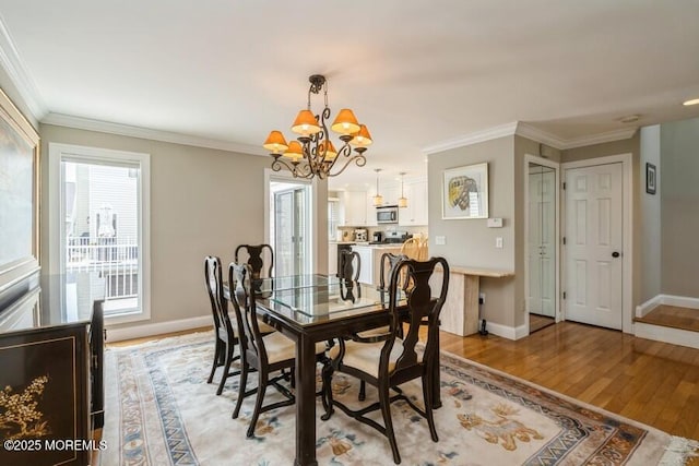 580 Patten Ave # 53, Long Branch, NJ 07740 - dining room featuring a chandelier, crown molding, baseboards, and light wood-style floors