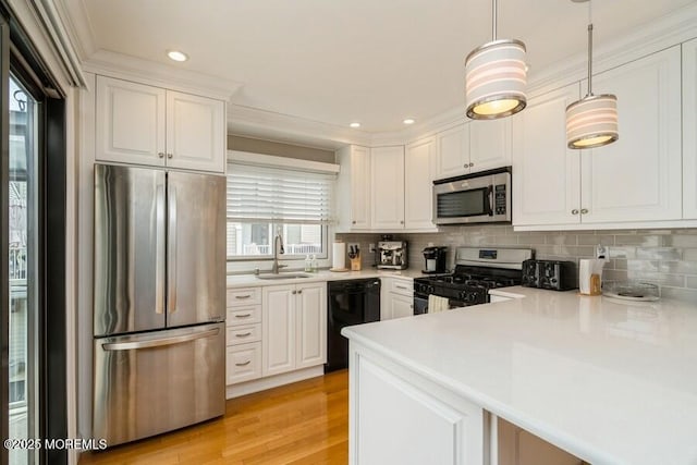 580 Patten Ave # 53, Long Branch, NJ 07740 - kitchen featuring stainless steel appliances, a sink, white cabinetry, light countertops, and backsplash