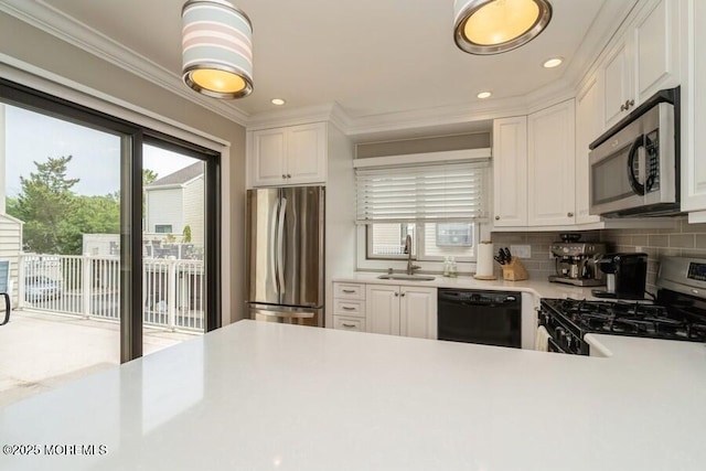 580 Patten Ave # 53, Long Branch, NJ 07740 - kitchen with stainless steel appliances, plenty of natural light, light countertops, a sink, and ornamental molding
