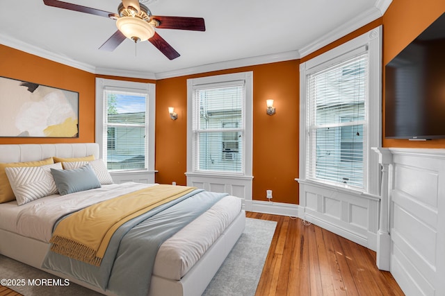 511 4th Ave, Asbury Park, NJ 07712 - bedroom featuring hardwood / wood-style flooring, crown molding, a wainscoted wall, and ceiling fan