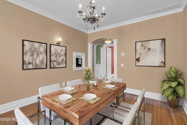 511 4th Ave, Asbury Park, NJ 07712 - dining space featuring ornate columns, arched walkways, wood finished floors, baseboards, and ornamental molding