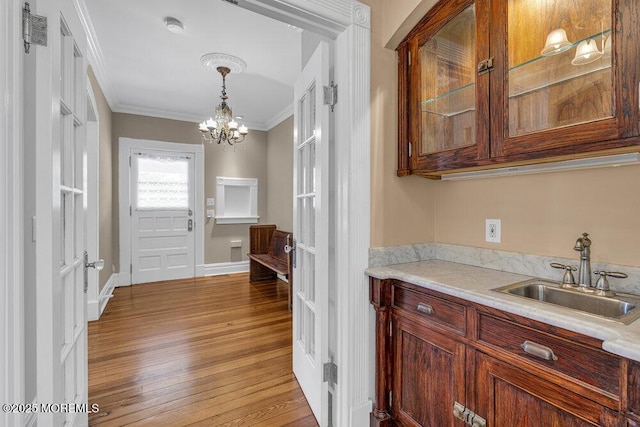 511 4th Ave, Asbury Park, NJ 07712 - bar area with a sink, crown molding, light wood-style flooring, a chandelier, and pendant lighting