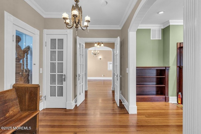 511 4th Ave, Asbury Park, NJ 07712 - foyer featuring a chandelier, arched walkways, wood-type flooring, ornamental molding, and baseboards