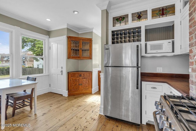 511 4th Ave, Asbury Park, NJ 07712 - kitchen with stainless steel appliances, dark countertops, light wood-style floors, white cabinetry, and glass insert cabinets