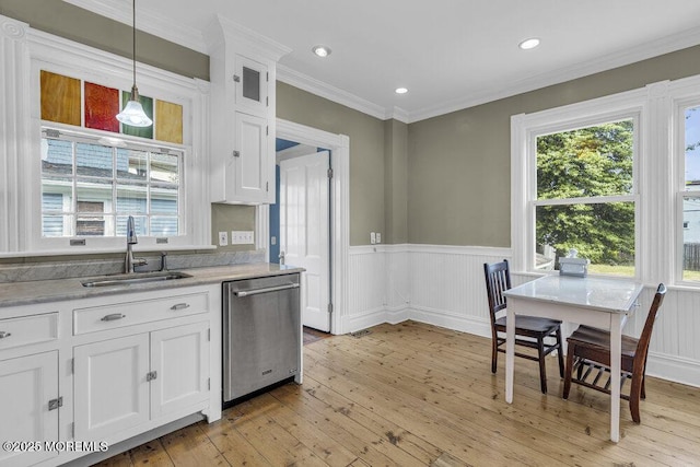 511 4th Ave, Asbury Park, NJ 07712 - kitchen featuring dishwasher, a sink, white cabinets, wainscoting, and healthy amount of natural light