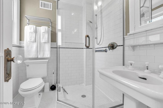511 4th Ave, Asbury Park, NJ 07712 - full bath with tile walls, toilet, a shower stall, tile patterned flooring, and wainscoting
