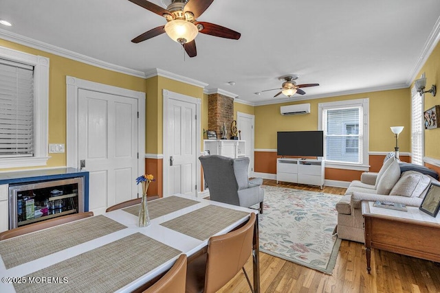 511 4th Ave, Asbury Park, NJ 07712 - living area with a ceiling fan, an AC wall unit, wood finished floors, ornamental molding, and baseboards