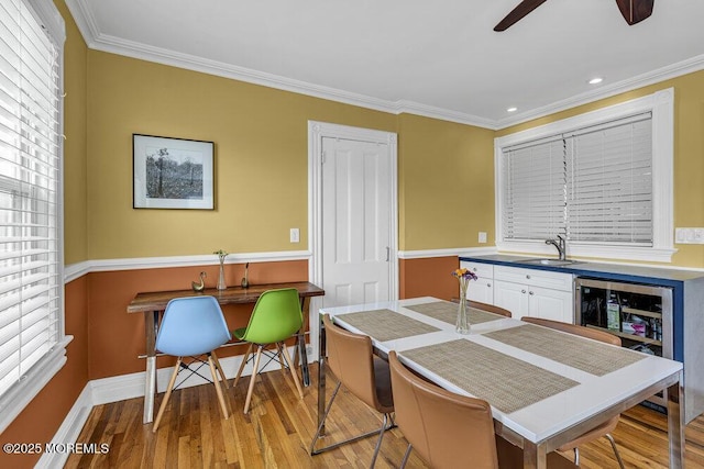 511 4th Ave, Asbury Park, NJ 07712 - kitchen featuring a sink, light wood-style floors, a ceiling fan, ornamental molding, and baseboards