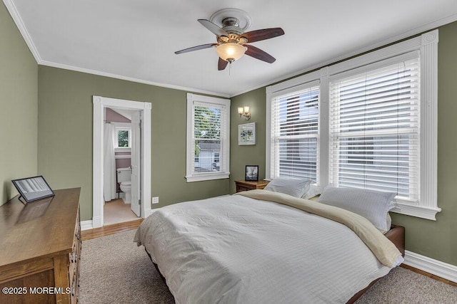 511 4th Ave, Asbury Park, NJ 07712 - bedroom with baseboards, crown molding, wood finished floors, a ceiling fan, and ensuite bathroom