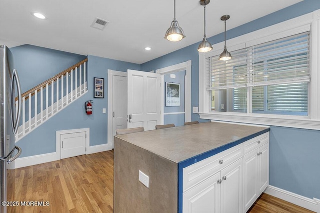 511 4th Ave, Asbury Park, NJ 07712 - kitchen featuring freestanding refrigerator, baseboards, white cabinetry, light wood-style flooring, and recessed lighting