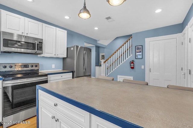 511 4th Ave, Asbury Park, NJ 07712 - kitchen featuring appliances with stainless steel finishes, white cabinetry, decorative light fixtures, and recessed lighting