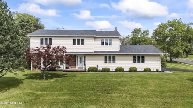 27 Sargent Rd, Freehold, NJ 07728 - view of front of property featuring a chimney, a front lawn, and roof with shingles