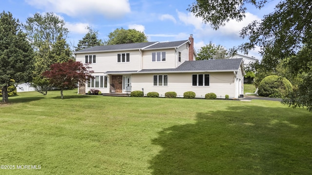 27 Sargent Rd, Freehold, NJ 07728 - traditional home with a chimney, a front yard, and a shingled roof