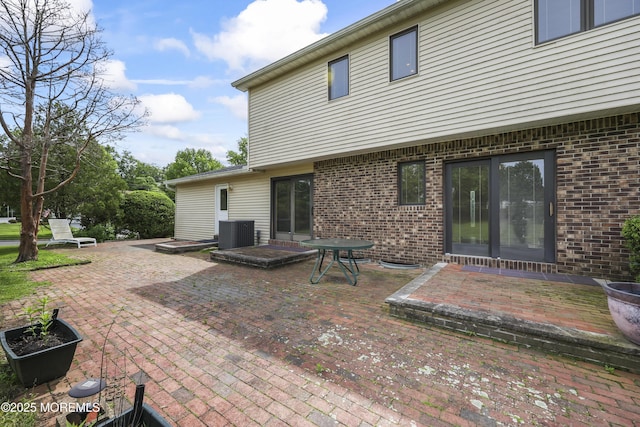 27 Sargent Rd, Freehold, NJ 07728 - back of house featuring brick siding, a patio, and central AC unit