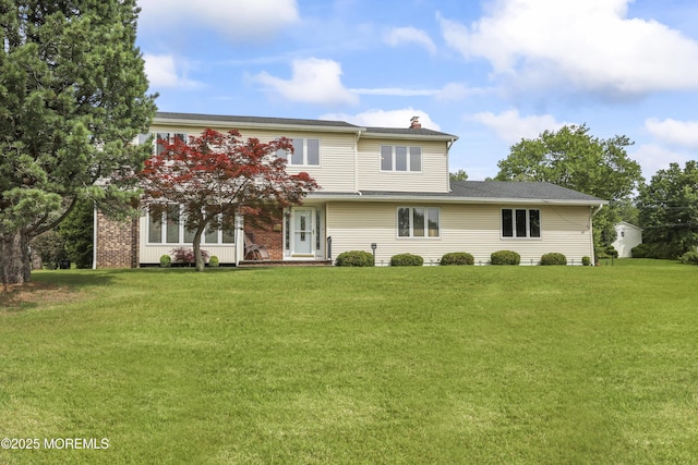 27 Sargent Rd, Freehold, NJ 07728 - view of front of property with a chimney and a front lawn