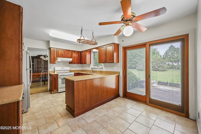 27 Sargent Rd, Freehold, NJ 07728 - kitchen featuring white appliances, under cabinet range hood, a peninsula, light countertops, and a ceiling fan