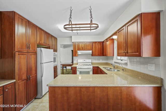 27 Sargent Rd, Freehold, NJ 07728 - kitchen with white appliances, under cabinet range hood, a sink, tasteful backsplash, and light stone countertops