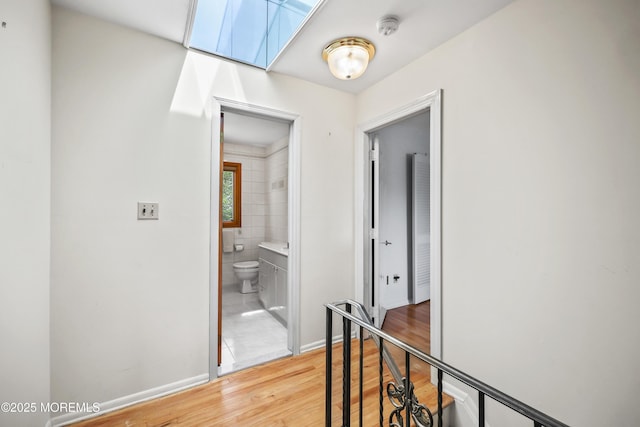 27 Sargent Rd, Freehold, NJ 07728 - hall featuring an upstairs landing, wood finished floors, and baseboards