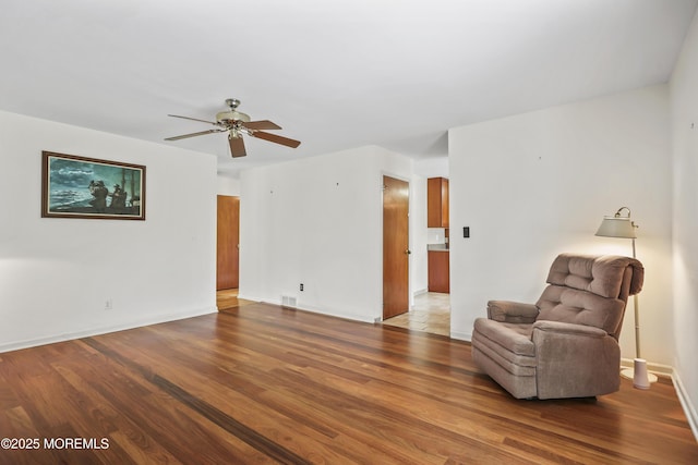 27 Sargent Rd, Freehold, NJ 07728 - sitting room featuring wood finished floors, ceiling fan, and baseboards