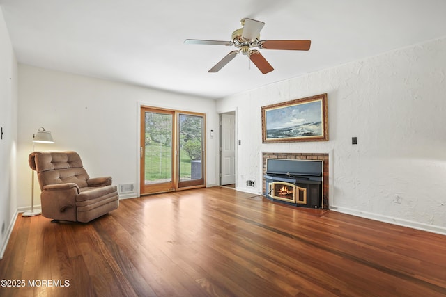 27 Sargent Rd, Freehold, NJ 07728 - living room with a fireplace with flush hearth, wood finished floors, a ceiling fan, and baseboards