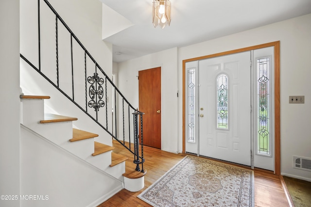 27 Sargent Rd, Freehold, NJ 07728 - entrance foyer with wood finished floors, stairs, and baseboards