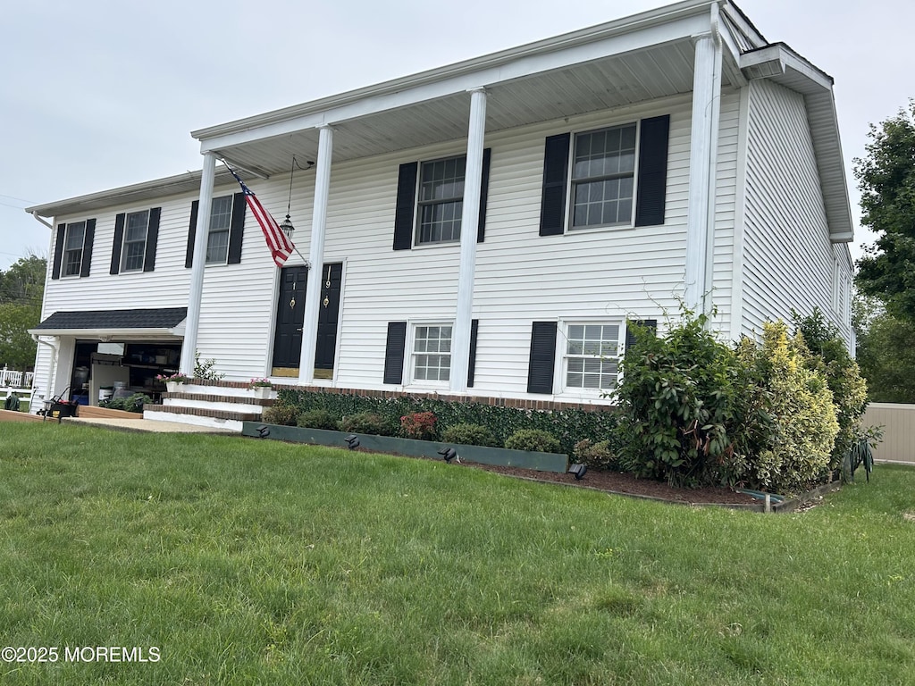19 Elm St, Beachwood, NJ 08722 - bi-level home featuring a front lawn and a garage