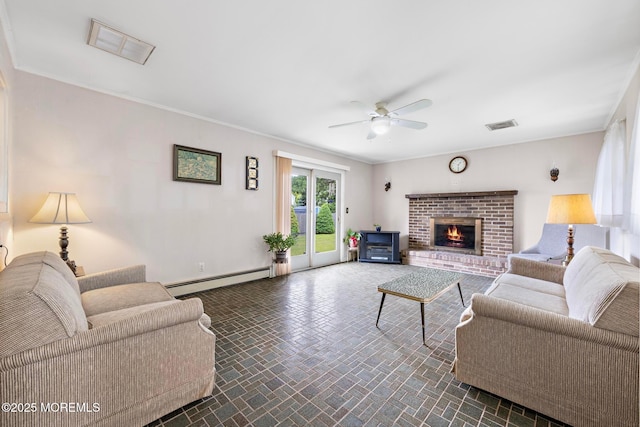 24 Heidl Ave, West Long Branch, NJ 07764 - living room with a baseboard heating unit, a ceiling fan, a brick fireplace, baseboards, and crown molding