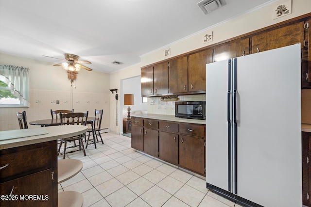24 Heidl Ave, West Long Branch, NJ 07764 - kitchen featuring freestanding refrigerator, black microwave, light tile patterned flooring, ceiling fan, and dark brown cabinetry