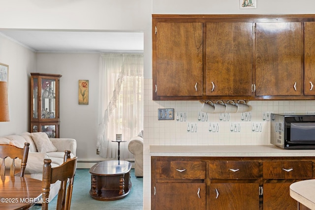 24 Heidl Ave, West Long Branch, NJ 07764 - kitchen with light countertops, tasteful backsplash, crown molding, and a baseboard heating unit