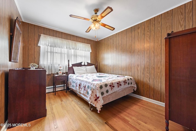 24 Heidl Ave, West Long Branch, NJ 07764 - bedroom featuring a baseboard radiator, wood finished floors, crown molding, ceiling fan, and wood walls