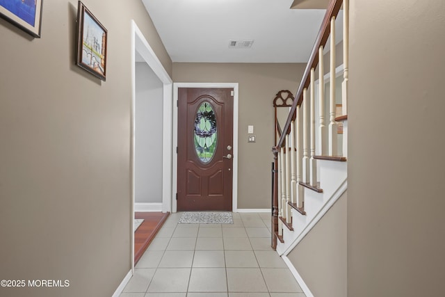 70 Walnut Ave, Red Bank, NJ 07701 - foyer entrance with light tile patterned floors, stairs, and baseboards
