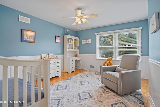 70 Walnut Ave, Red Bank, NJ 07701 - bedroom featuring a wainscoted wall, a nursery area, and ceiling fan