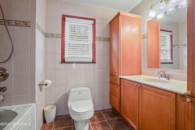 70 Walnut Ave, Red Bank, NJ 07701 - bathroom featuring vanity, tile walls, toilet, tile patterned floors, and tub / shower combination
