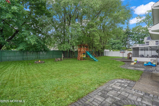 70 Walnut Ave, Red Bank, NJ 07701 - view of yard with a sunroom, a playground, an outdoor fire pit, and a patio